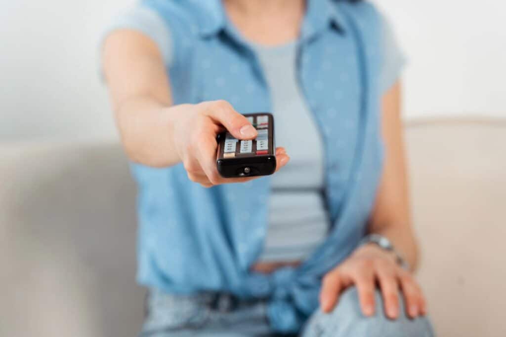 Person holding TV remote for ITV soaps schedule 26th to 30th October 2026 and spoilers.